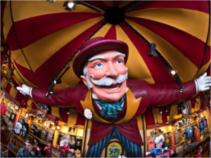 A statue of a circus performer under a circus tent